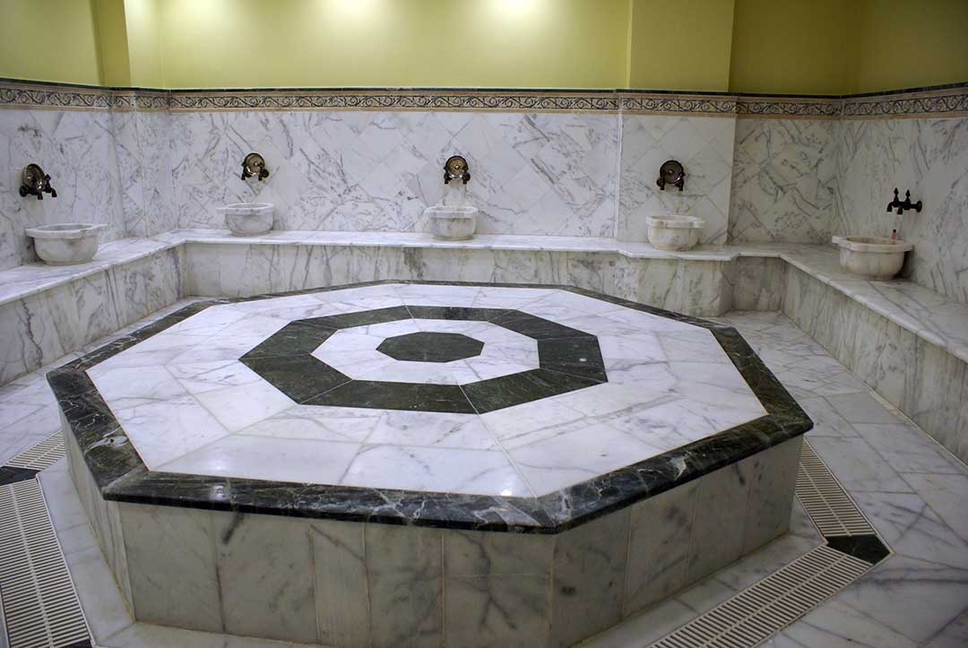 Turkish Bath hot room covered in marble with the hexagonal heating platform in the centre