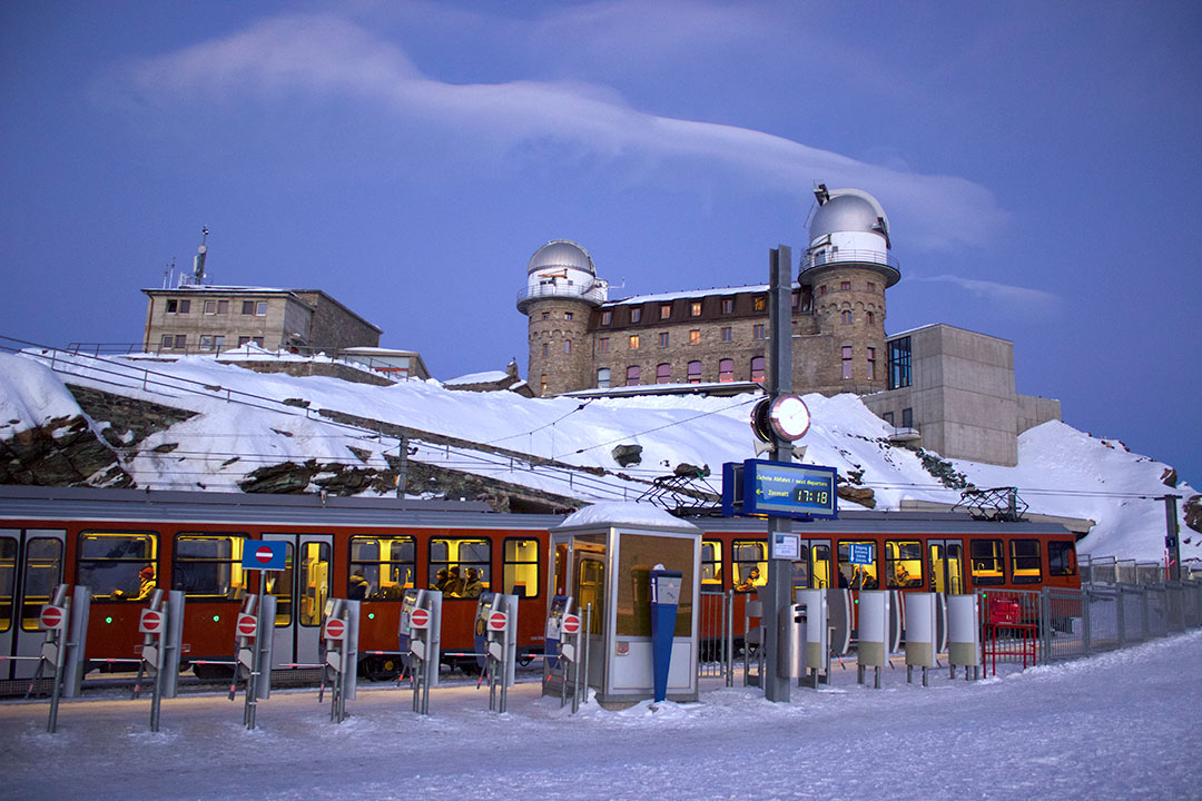 The red train stopped at the train station that takes you up to the starting point for snow sledding