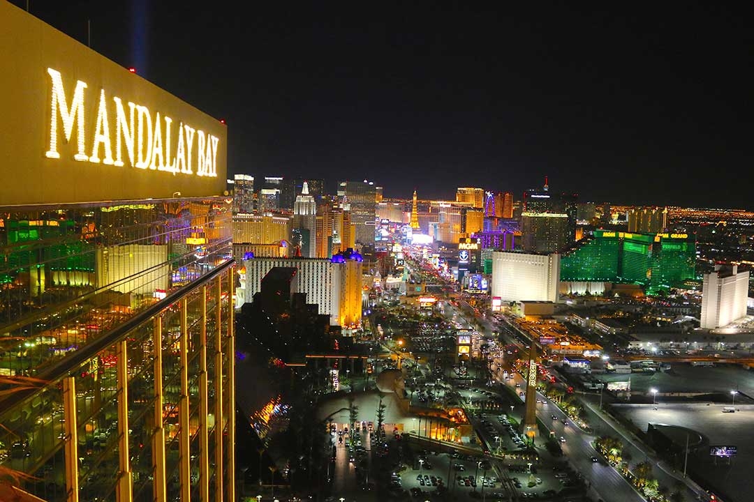 View from the top of Mandalay Bay of Las Vegas at night all lit up with colourful lights