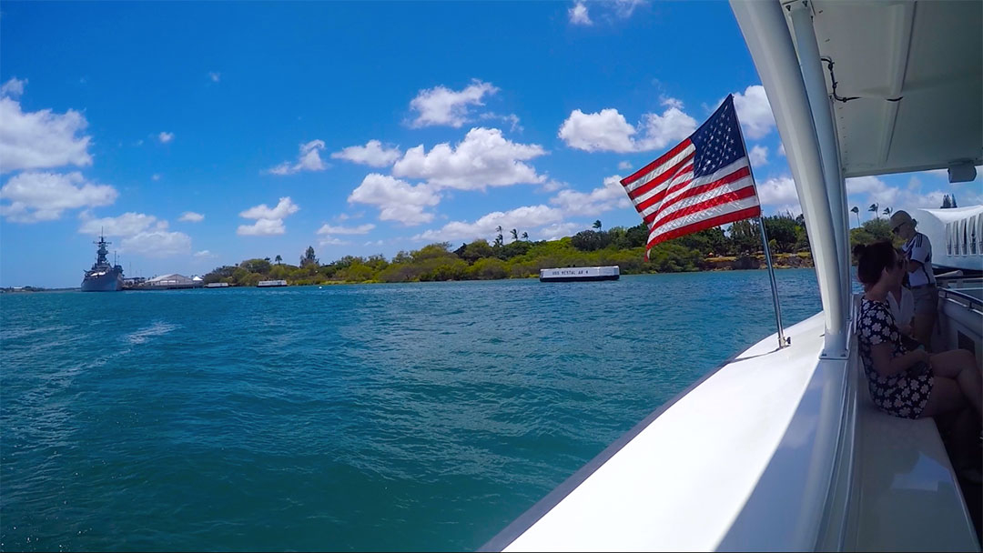 Sitting at the back of the ferry looking out over the ocean with the American flag blowing in the breeze as we leave Pearl Harbour Hawaii