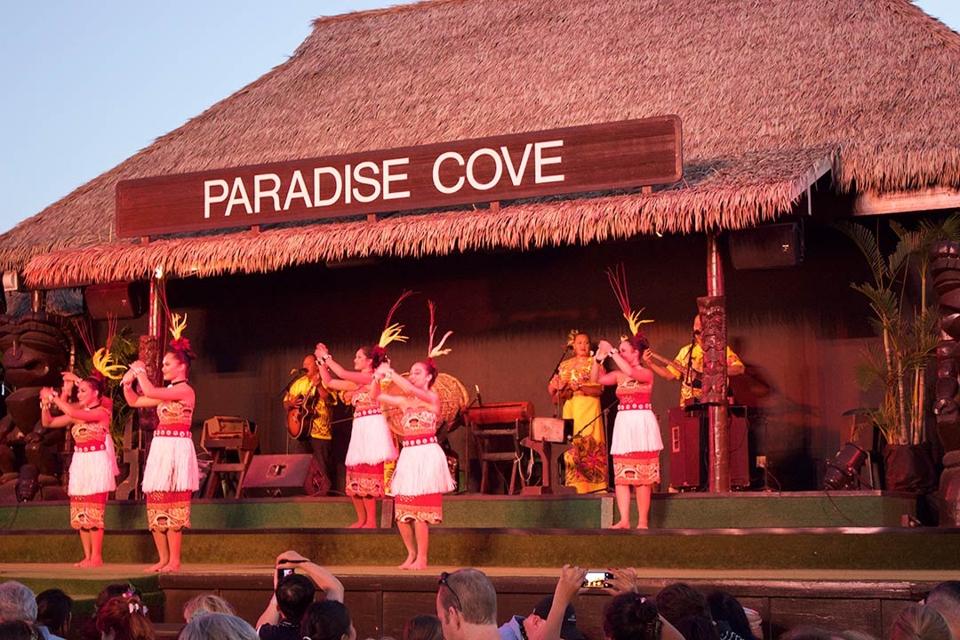 Female dancers performing on stage at sunset at the Paradise Cove Luau