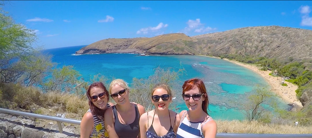 Selfie photo of 4 girls with beautiful Hanauma Bay in the background with its blue green water and mountains