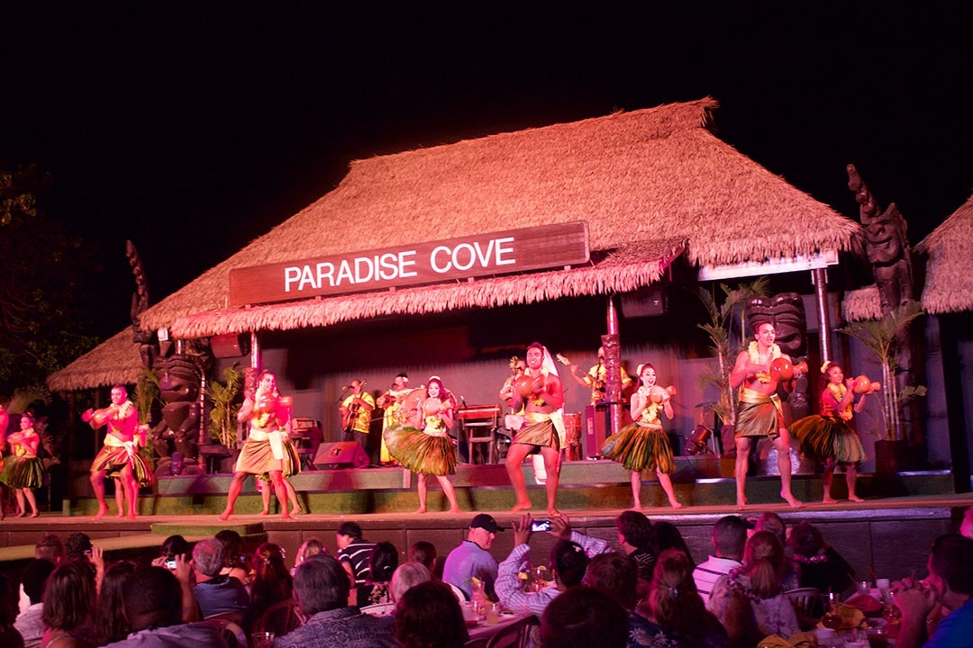 Female and male dancers performing on stage at sunset at the Paradise Cove Luau