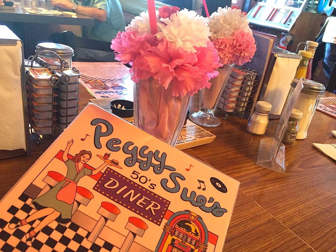 Funky diner menu and fake milkshake table decorations at Peggy Sue's 50s Diner