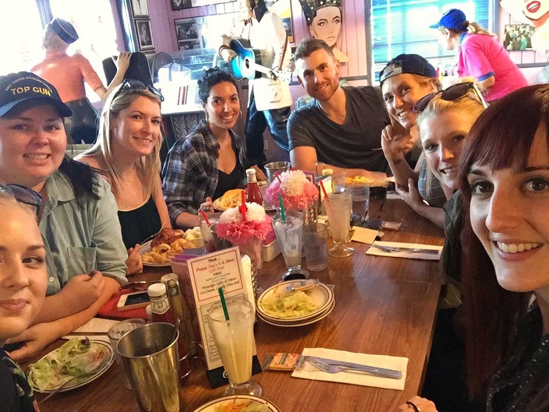 Group of friends sitting around a table having lunch at Peggy Sue's 50s Diner