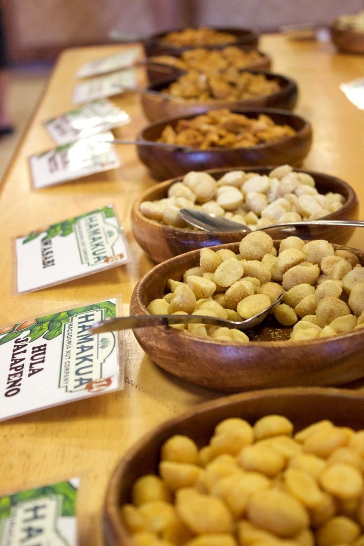 Close up shot of wooden bowls containing different flavoured nuts at Hamakua Macadamia Nut Farm