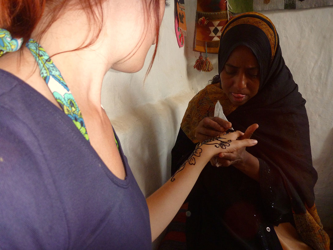 Henna hand painting by a local Nubian village woman inside her home