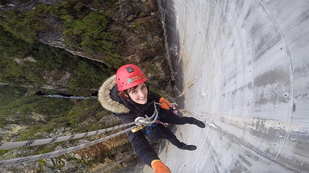 Looking down from above while I smile abseiling Gordon Dam