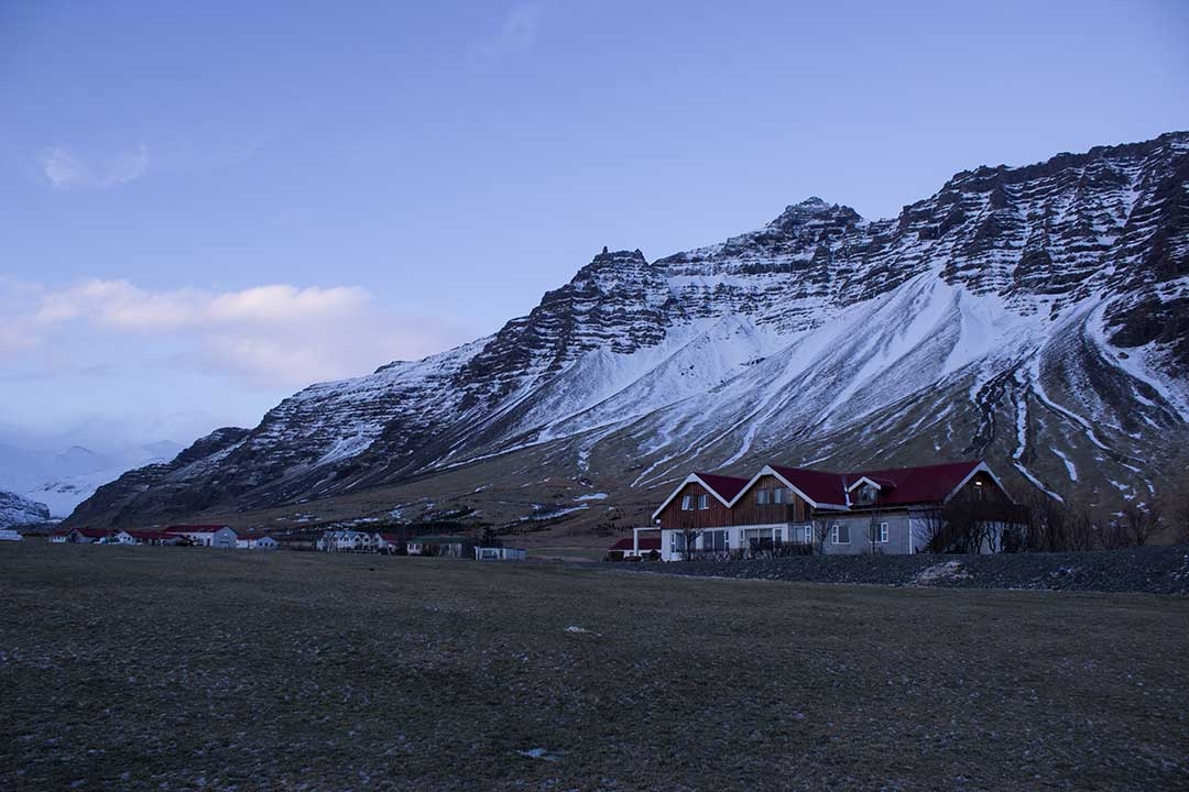 Houses in Iceland during winter with mountains in the background