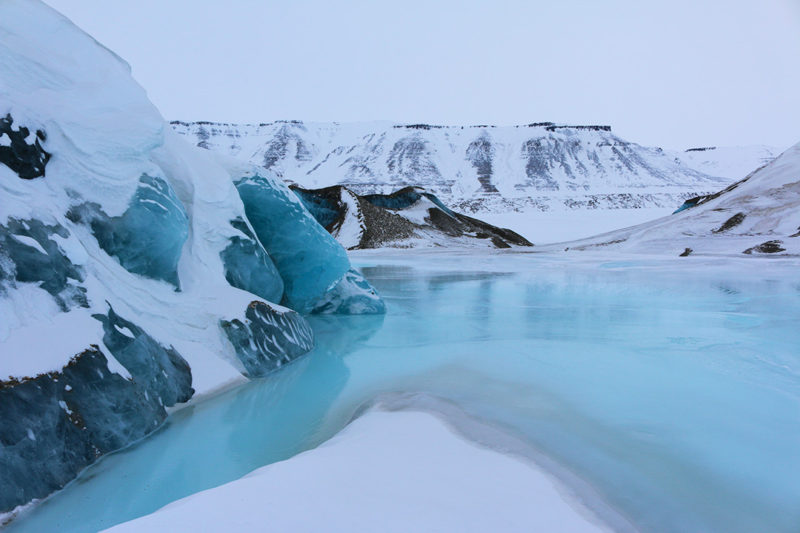 Blue frozen lakes in the Arctic in Svalbard