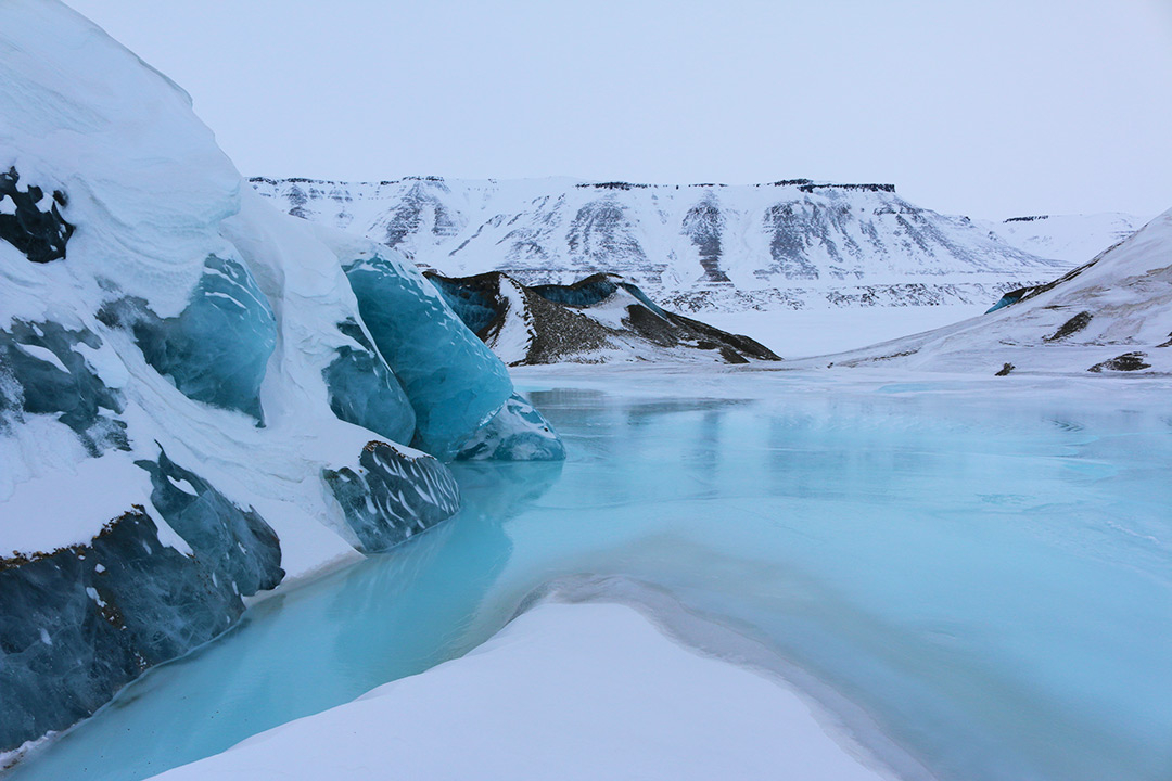 Blue frozen lakes in the Arctic in Svalbard